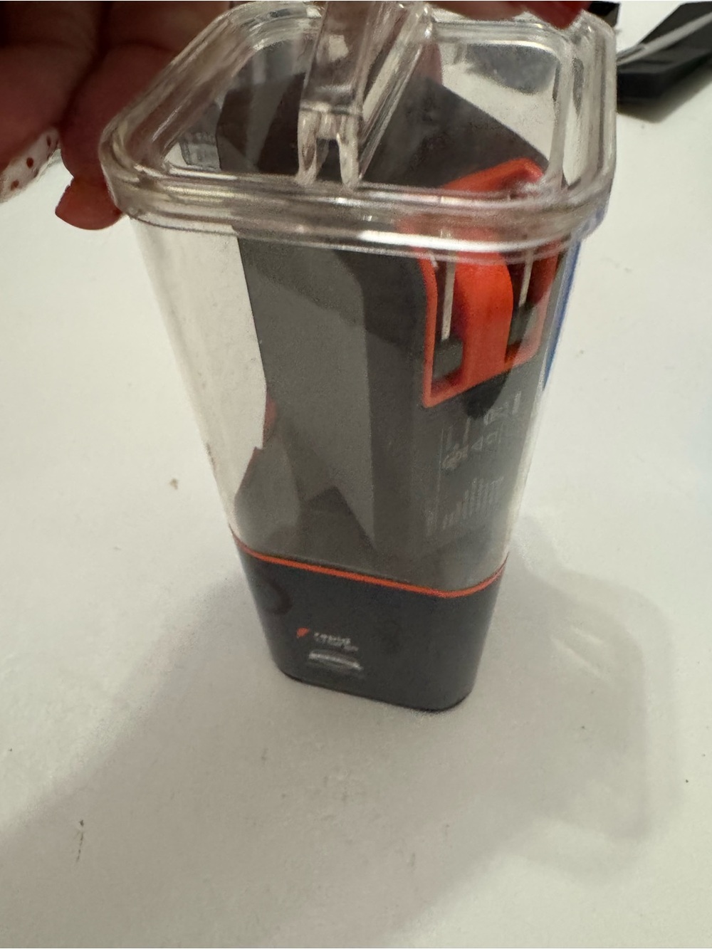 Compact Black and Orange Electronic Accessory in Clear Case